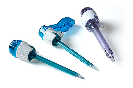 Still Life Close Up of Pile of Empty Syringe Needles with Red Safety Caps in Studio with White Background